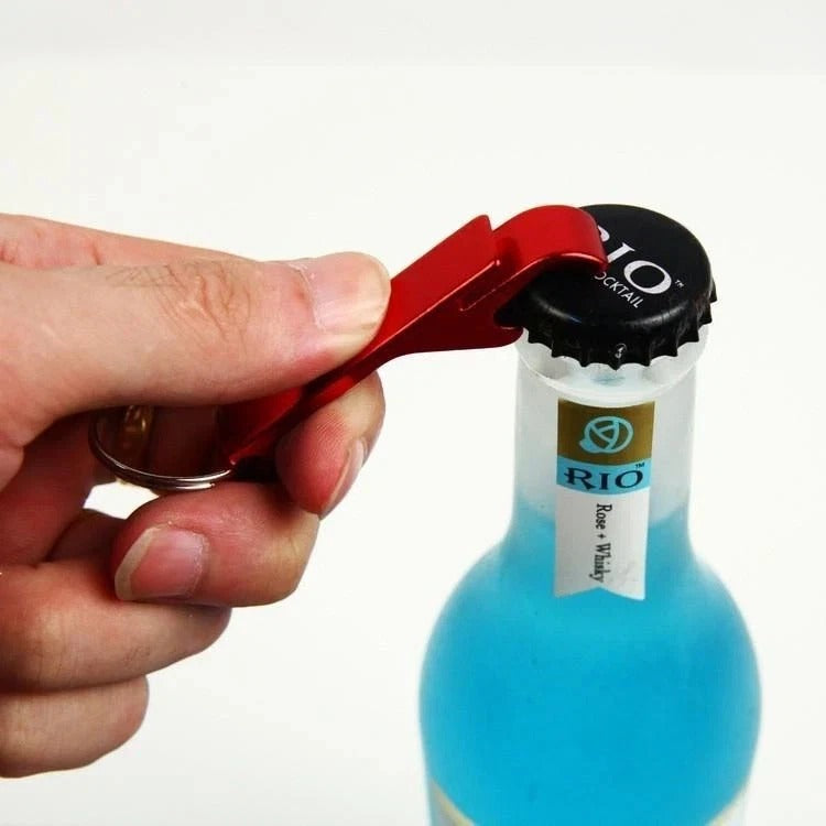 Red metal bottle opener keyring with key loop, removing a bottle cap
