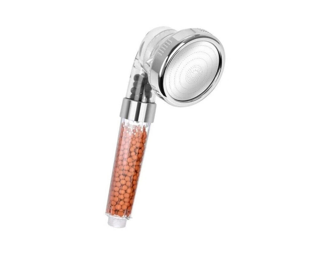 Chrome shower head with round spray face and amber bead-filled filter handle