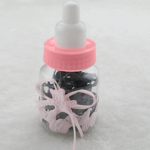 Fillable candy bottle with pink cap, clear body, and ribbon with bunny-shaped charms.