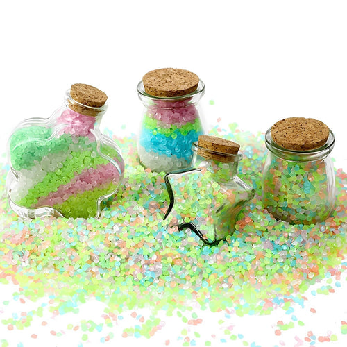 Glow-in-the-dark pebble stones in bottles, multi-coloured pink blue green chips