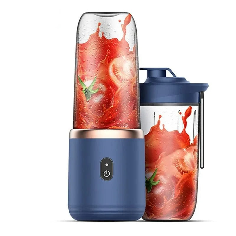 Blue portable mini blender base with clear cup showing red fruit splash